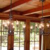 Pair of iron and blown glass dining chandeliers - Rising Sun forge